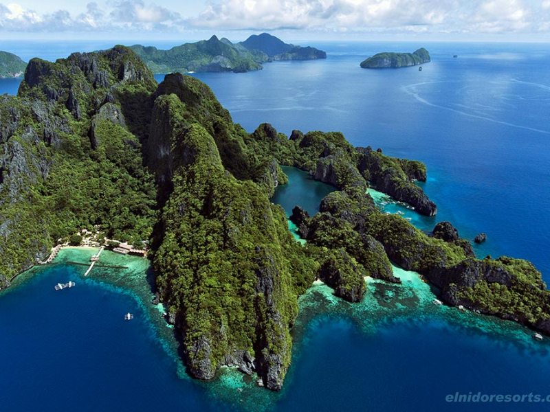 Green mountain jungle island in blue ocean
