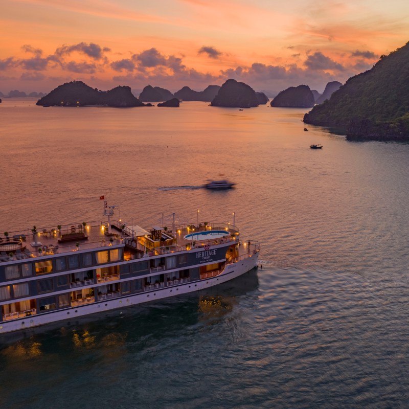 Ship sailing Halong Bay at sunset