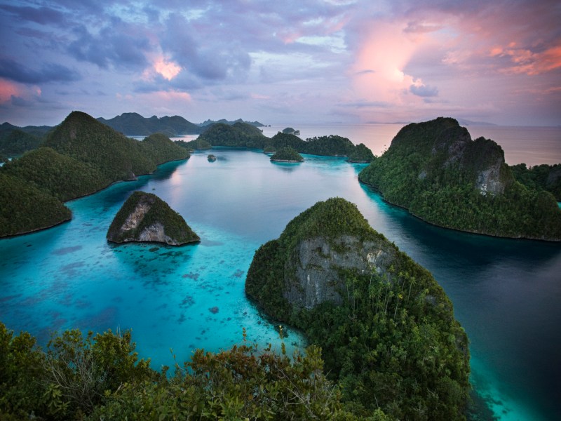 Green mountain jungle island in blue ocean