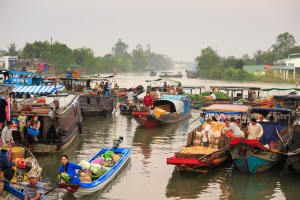 Boats with produce floating on river