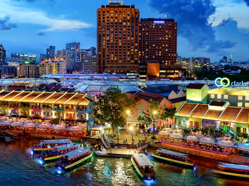Colorful city street on river at night