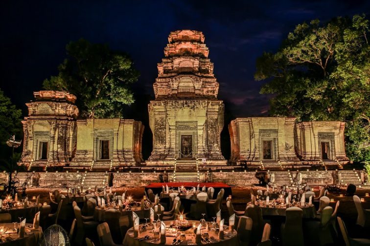Tables set for dinner at Cambodian temple at night
